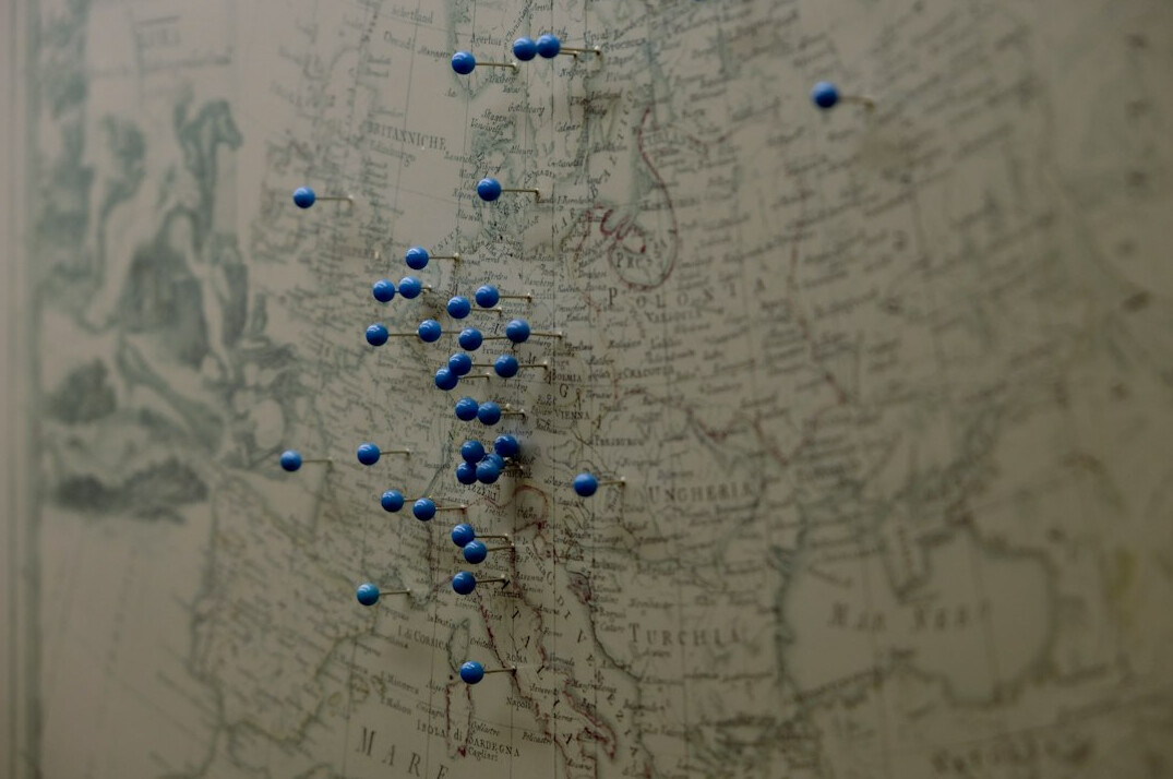 Old paper map spread on a table with pins