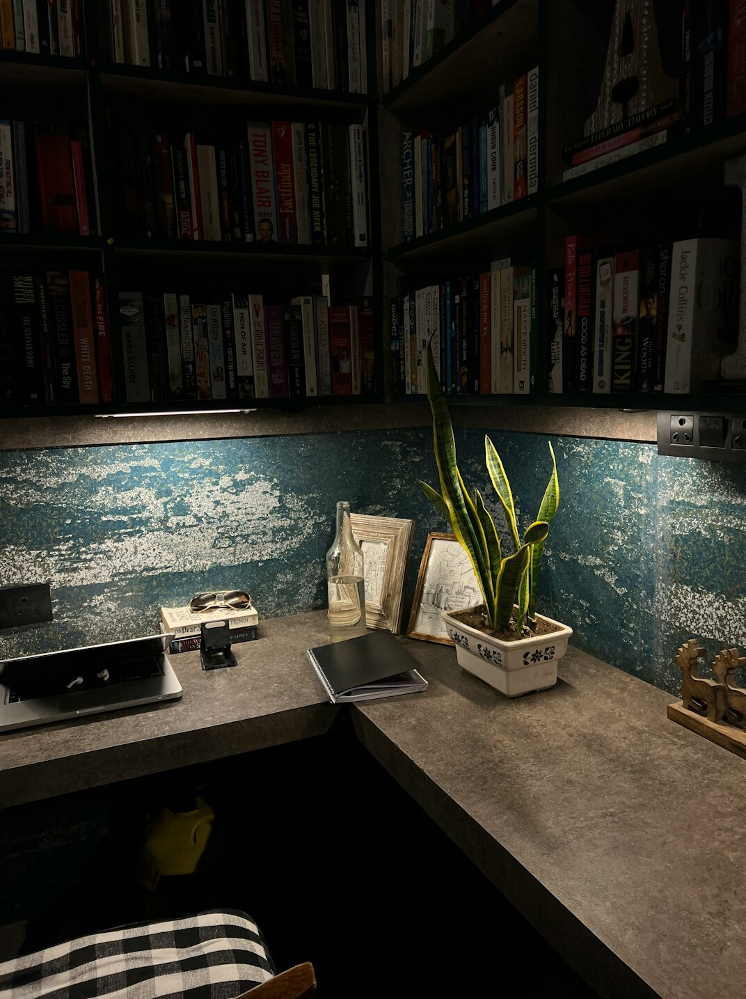 Desk with books, notes and a lamp in a study