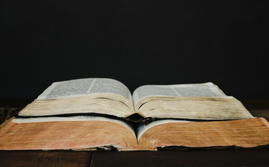 Open book with pages fanned out on a table