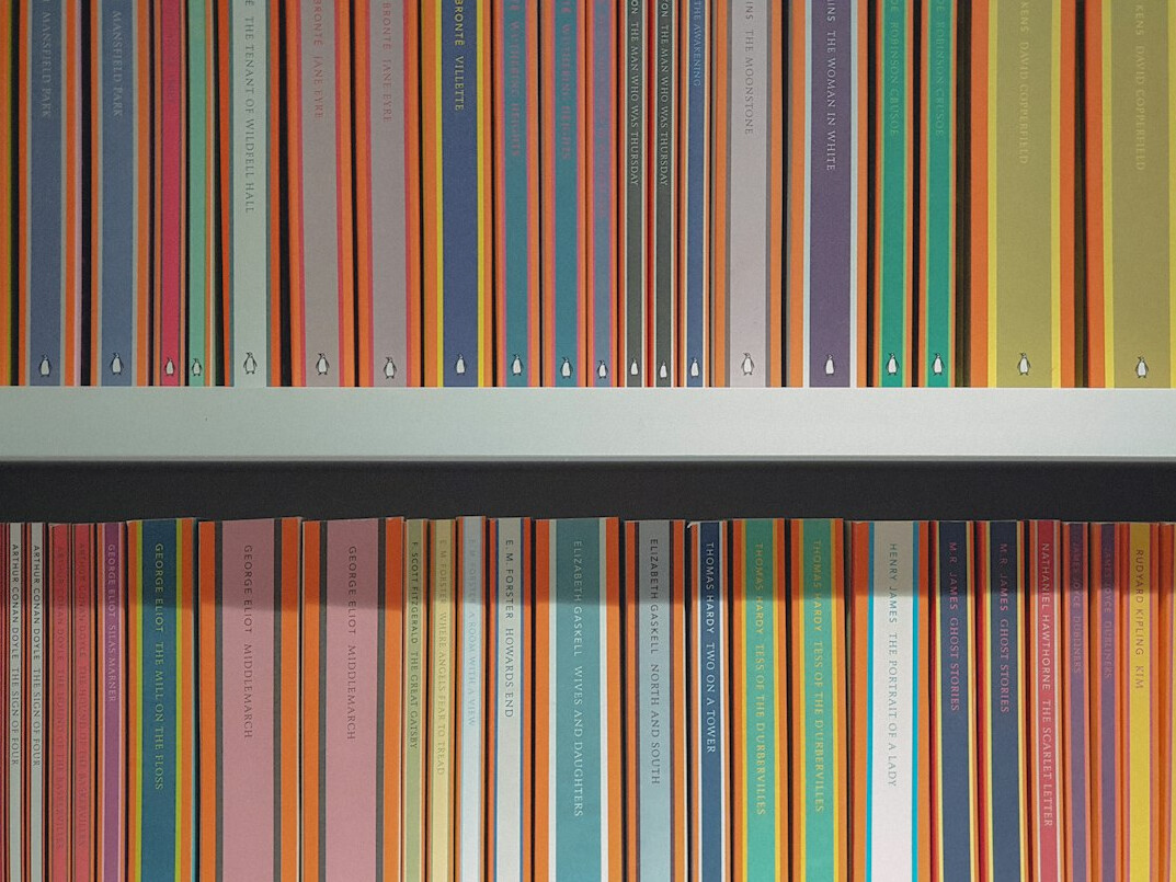 Stack of colorful hardcover books on a shelf